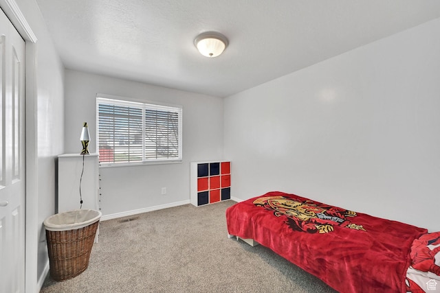carpeted bedroom featuring baseboards and visible vents