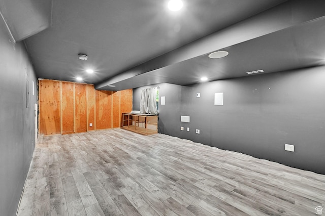 finished below grade area featuring wood finished floors and recessed lighting