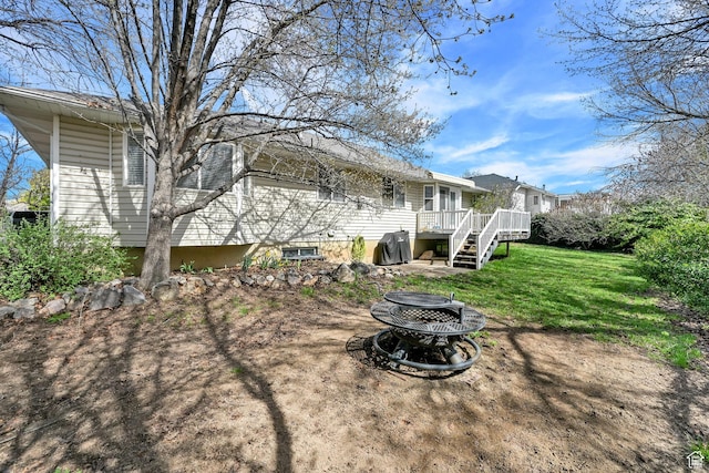 view of yard featuring a fire pit and a wooden deck