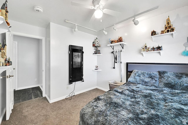 bedroom featuring track lighting, baseboards, ceiling fan, and carpet
