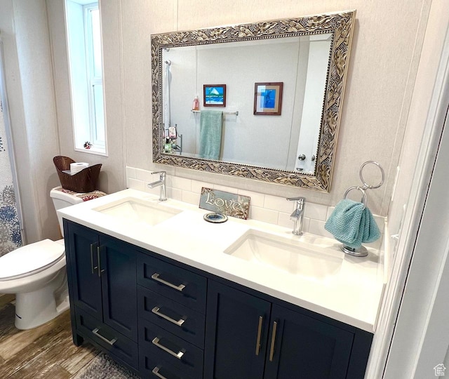 3203 S Nina Loop, Garden City, UT 84028 - full bath with toilet, a sink, double vanity, and decorative backsplash