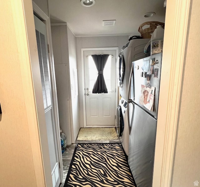 3203 S Nina Loop, Garden City, UT 84028 - washroom featuring visible vents, stacked washer / dryer, laundry area, and a heating unit