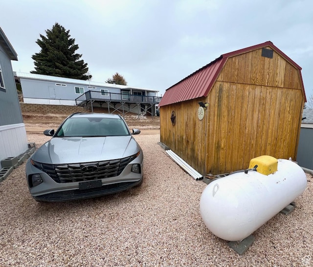 3203 S Nina Loop, Garden City, UT 84028 - view of home's exterior with an outdoor structure, a gambrel roof, and a shed