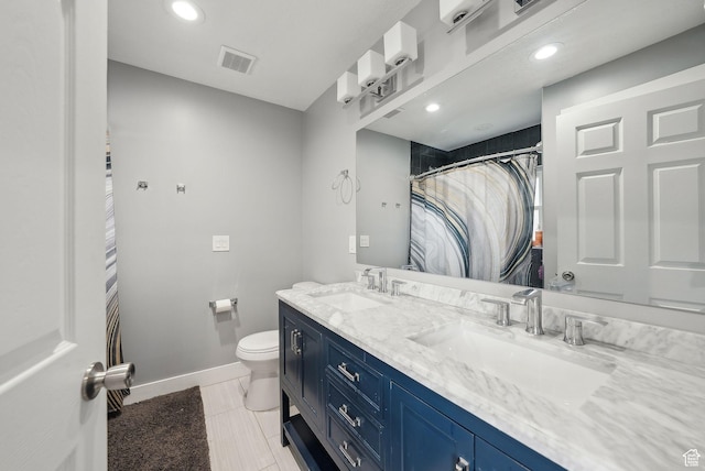 bathroom with baseboards, visible vents, a sink, and toilet