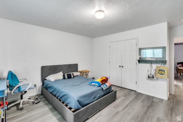 3127 W 525 N, West Point, UT 84015 - bedroom with baseboards, a textured ceiling, a closet, and wood finished floors