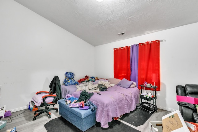 3127 W 525 N, West Point, UT 84015 - bedroom with wood finished floors, a textured ceiling, baseboards, and visible vents