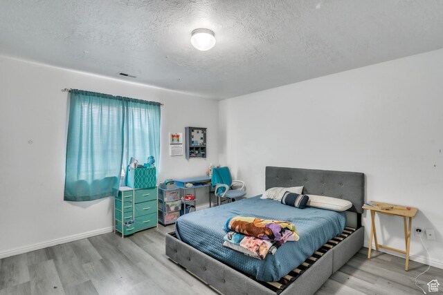 3127 W 525 N, West Point, UT 84015 - bedroom with baseboards, visible vents, a textured ceiling, and wood finished floors