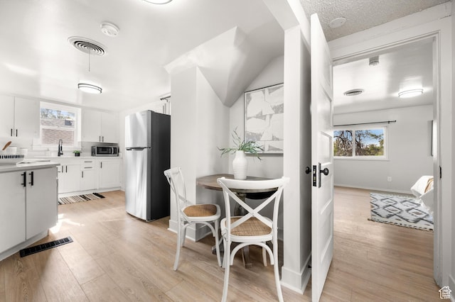 655 S 800 E, Salt Lake City, UT 84102 - kitchen with white cabinets, visible vents, stainless steel appliances, and plenty of natural light