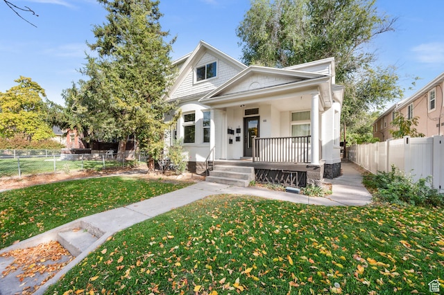 655 S 800 E, Salt Lake City, UT 84102 - bungalow-style house with fence private yard, a porch, and a front lawn