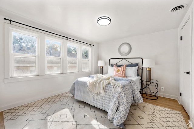 655 S 800 E, Salt Lake City, UT 84102 - bedroom with baseboards, visible vents, and wood finished floors