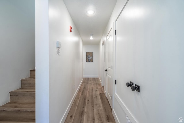 5399 S Cerulean Ln Unit 95, St George, UT 84790 - hallway featuring light wood-style flooring, baseboards, and stairway