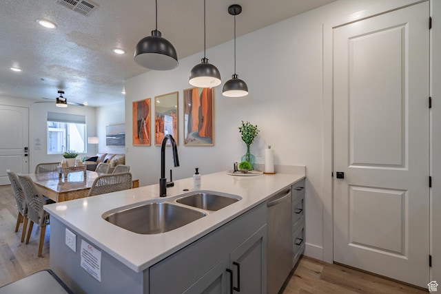 5399 S Cerulean Ln Unit 95, St George, UT 84790 - kitchen featuring stainless steel dishwasher, a sink, light wood finished floors, visible vents, and a ceiling fan