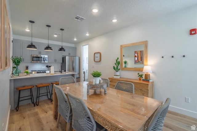 5399 S Cerulean Ln Unit 95, St George, UT 84790 - dining area featuring recessed lighting, baseboards, a textured ceiling, visible vents, and light wood-style flooring