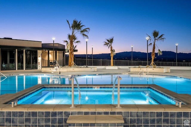 5399 S Cerulean Ln Unit 95, St George, UT 84790 - pool with a hot tub, fence, a patio area, and a mountain view