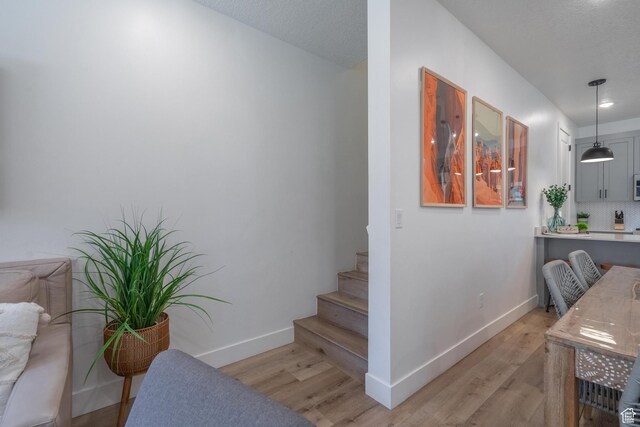 5399 S Cerulean Ln Unit 95, St George, UT 84790 - stairs featuring baseboards, a textured ceiling, and wood finished floors