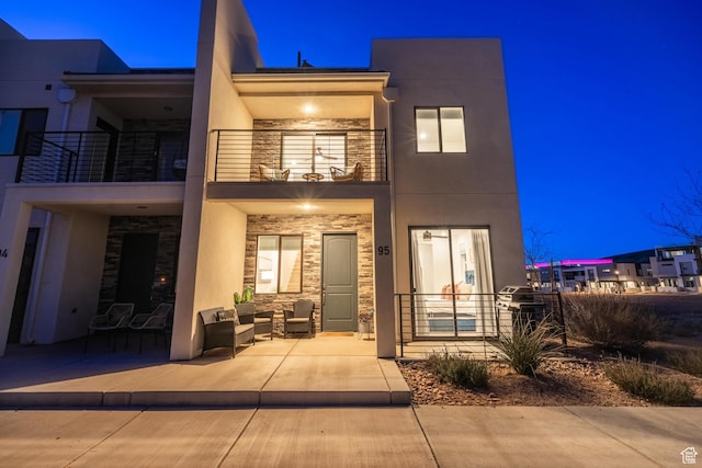5399 S Cerulean Ln Unit 95, St George, UT 84790 - view of front of home featuring stone siding, a balcony, and stucco siding
