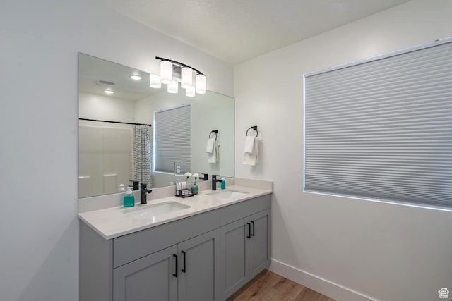 5399 S Cerulean Ln Unit 95, St George, UT 84790 - bathroom with double vanity, wood finished floors, baseboards, and a sink