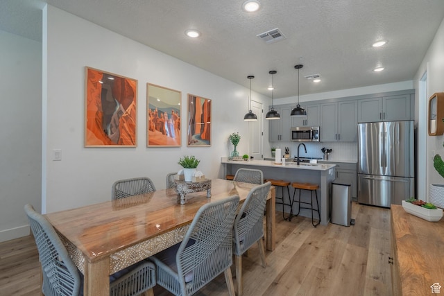 5399 S Cerulean Ln Unit 95, St George, UT 84790 - dining room featuring recessed lighting, a textured ceiling, visible vents, and light wood-style floors