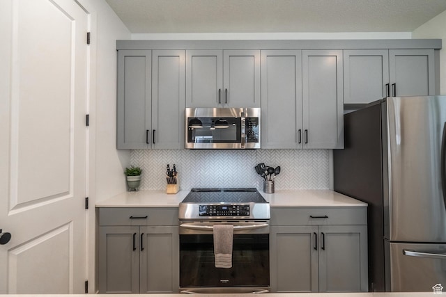 5399 S Cerulean Ln Unit 95, St George, UT 84790 - kitchen with gray cabinets, light countertops, tasteful backsplash, and stainless steel appliances