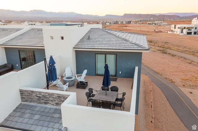 5399 S Cerulean Ln Unit 95, St George, UT 84790 - back of house featuring a tile roof, stucco siding, a mountain view, a fire pit, and a patio area