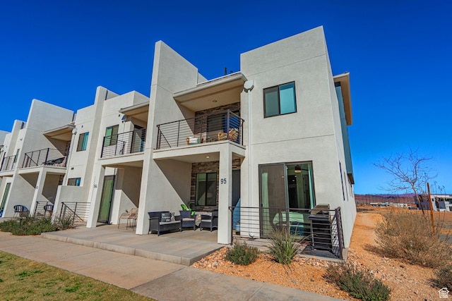 5399 S Cerulean Ln Unit 95, St George, UT 84790 - exterior space featuring outdoor lounge area, a balcony, stucco siding, and a patio