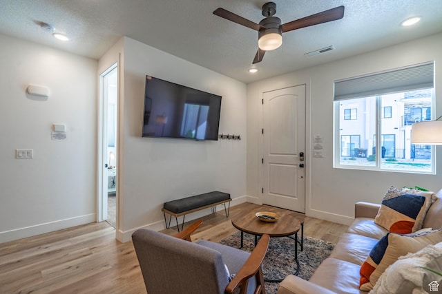 5399 S Cerulean Ln Unit 95, St George, UT 84790 - living area with light wood-type flooring, a textured ceiling, ceiling fan, and visible vents