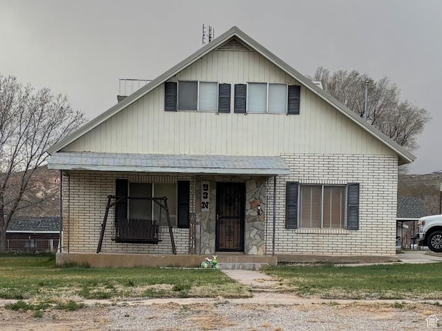 view of front of house with covered porch and brick siding