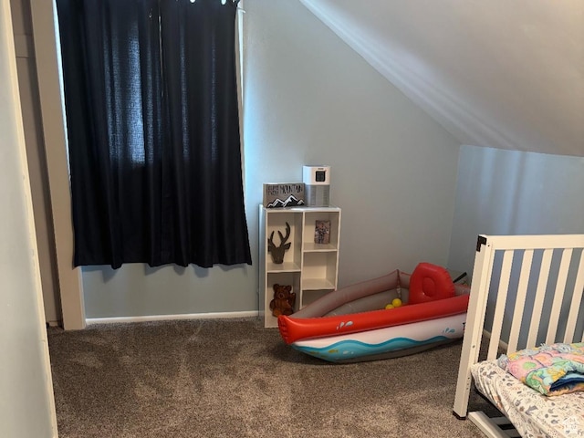 bedroom with carpet floors, baseboards, and lofted ceiling