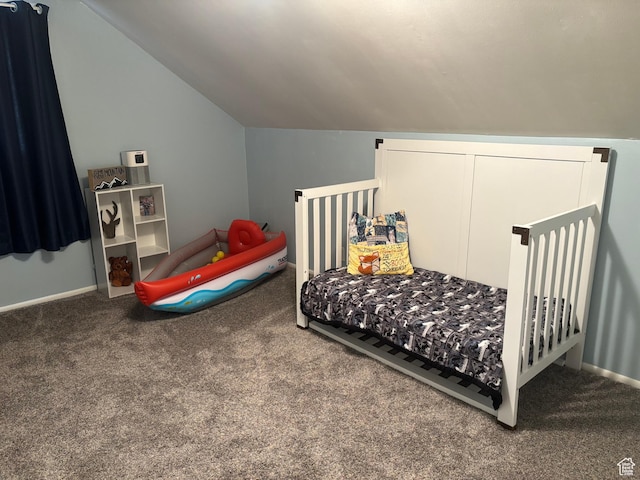 carpeted bedroom featuring baseboards and lofted ceiling