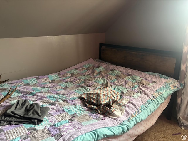 carpeted bedroom featuring lofted ceiling