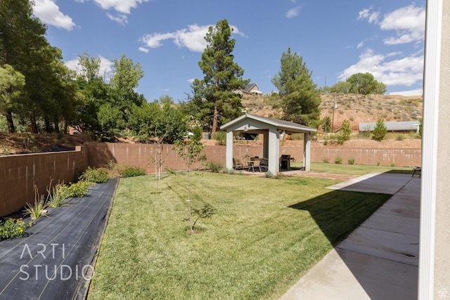 view of yard featuring a fenced backyard, a gazebo, and a patio area