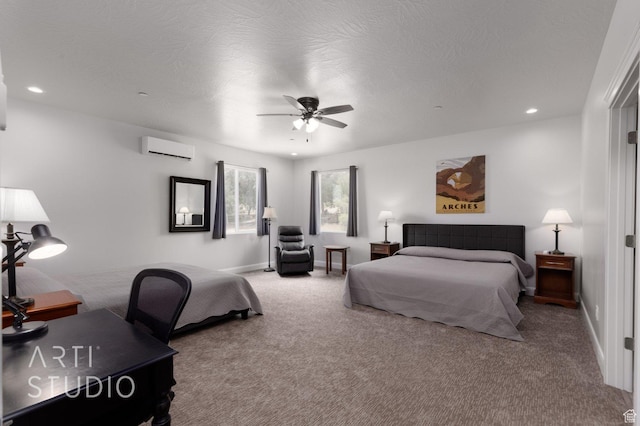 carpeted bedroom with recessed lighting, baseboards, a textured ceiling, ceiling fan, and a wall mounted air conditioner