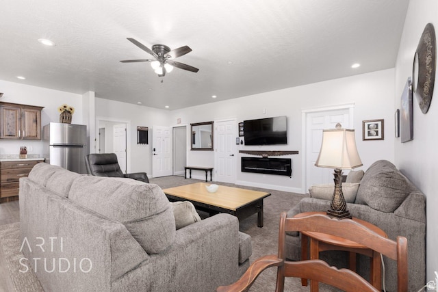 living room featuring carpet floors, a textured ceiling, recessed lighting, and ceiling fan