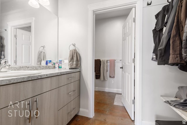 bathroom featuring baseboards and vanity