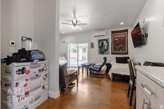 bedroom with access to exterior, a wall unit AC, a textured ceiling, finished concrete flooring, and recessed lighting