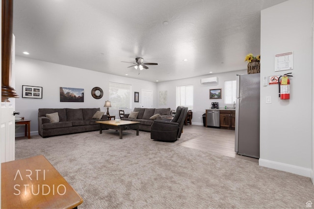 carpeted living room with baseboards, a wall mounted AC, ceiling fan, and recessed lighting