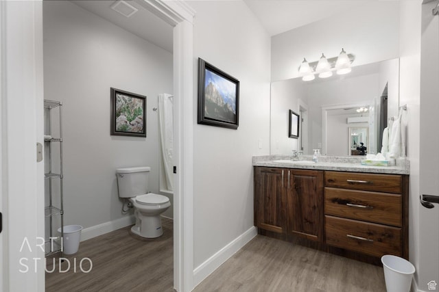 full bathroom with visible vents, toilet, vanity, and wood finished floors