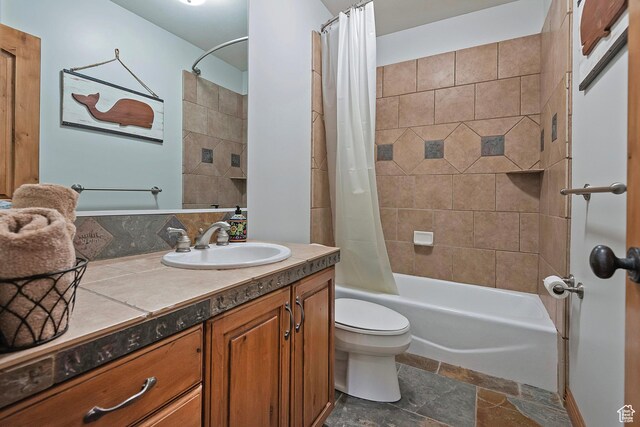 5888 E Pioneer Fork Rd N, Salt Lake City, UT 84108 - full bathroom featuring vanity, toilet, shower / bath combo with shower curtain, and stone tile flooring