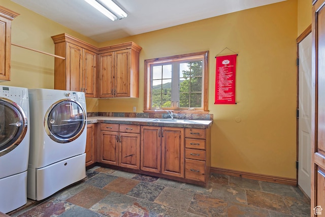 5888 E Pioneer Fork Rd N, Salt Lake City, UT 84108 - clothes washing area featuring a sink, stone tile flooring, cabinet space, and separate washer and dryer