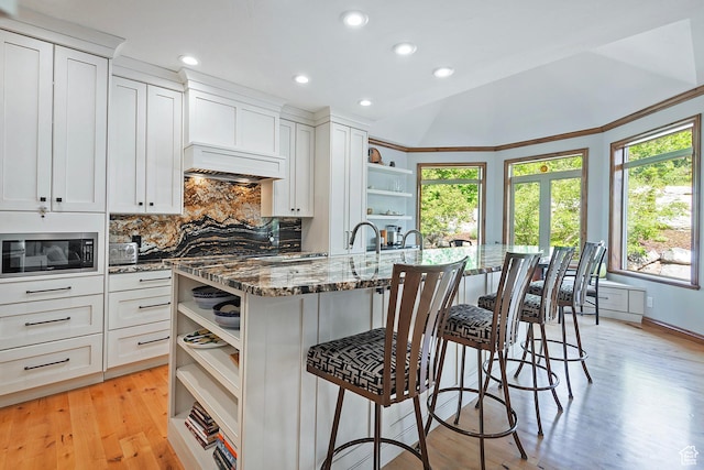 5888 E Pioneer Fork Rd N, Salt Lake City, UT 84108 - kitchen featuring white cabinets, custom exhaust hood, stainless steel microwave, stone countertops, and open shelves