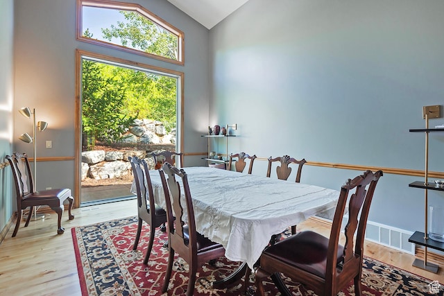 5888 E Pioneer Fork Rd N, Salt Lake City, UT 84108 - dining room featuring visible vents, baseboards, vaulted ceiling, and wood finished floors