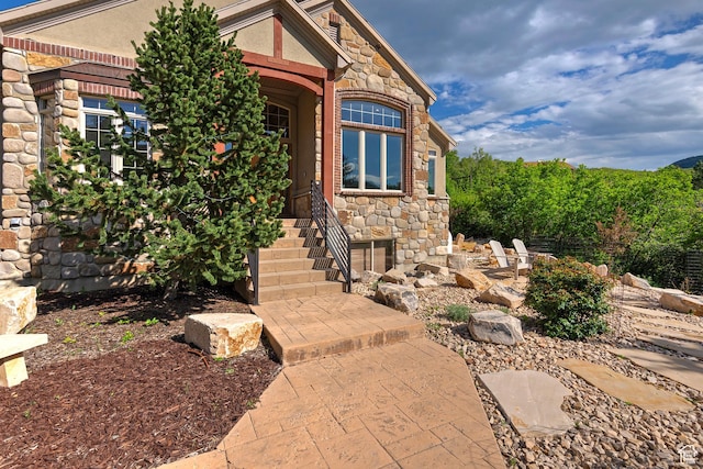 5888 E Pioneer Fork Rd N, Salt Lake City, UT 84108 - doorway to property featuring stone siding and stucco siding