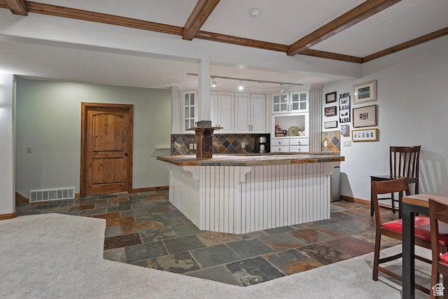 5888 E Pioneer Fork Rd N, Salt Lake City, UT 84108 - kitchen featuring stone tile floors, backsplash, white cabinetry, glass insert cabinets, and visible vents
