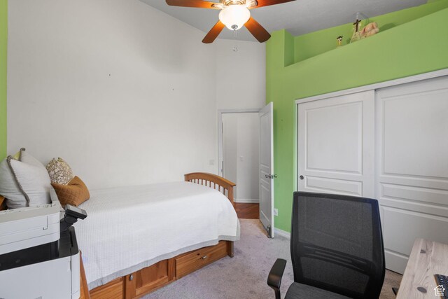 13968 S Hawberry Rd E, Draper, UT 84020 - bedroom with light colored carpet, a closet, baseboards, and a ceiling fan
