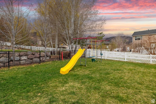 13968 S Hawberry Rd E, Draper, UT 84020 - playground at dusk featuring a playground, fence, and a lawn