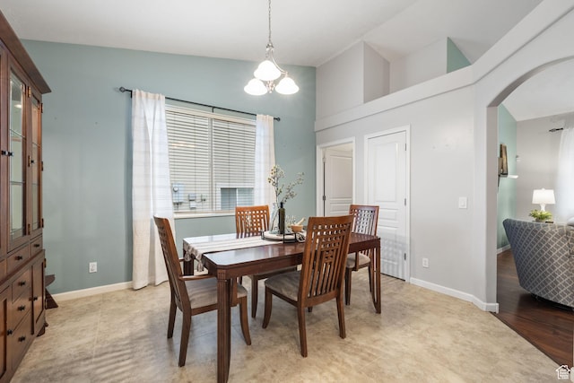 13968 S Hawberry Rd E, Draper, UT 84020 - dining room with an inviting chandelier, light wood-style flooring, arched walkways, and baseboards