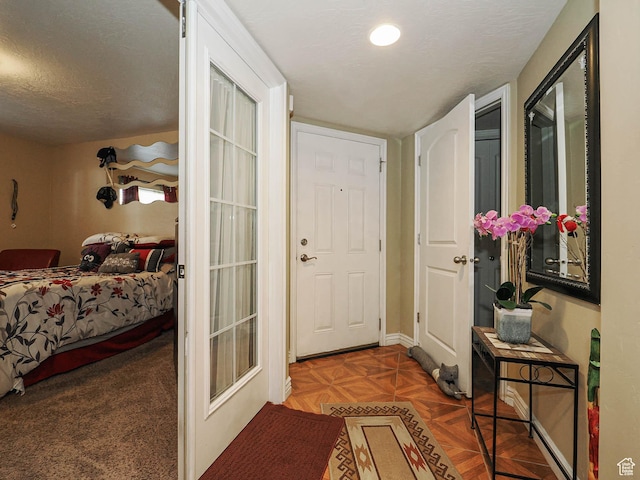 interior space with baseboards and a textured ceiling