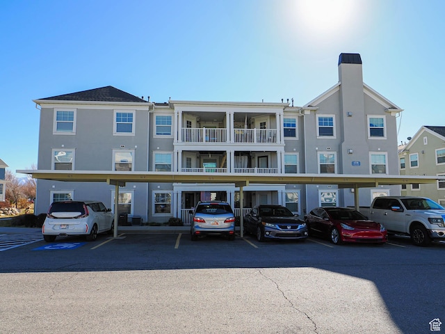 view of building exterior with covered parking