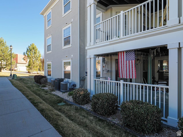 view of side of home with stucco siding and central air condition unit
