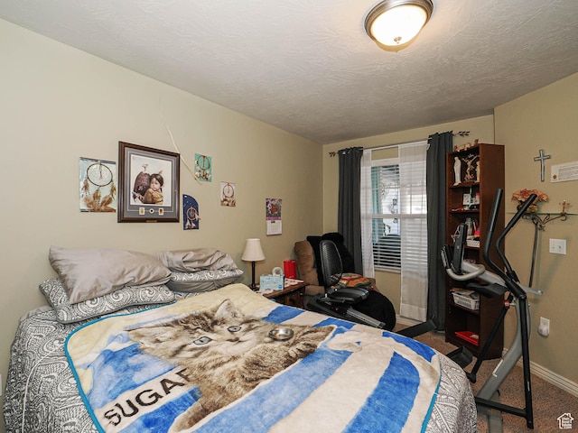 carpeted bedroom featuring baseboards and a textured ceiling
